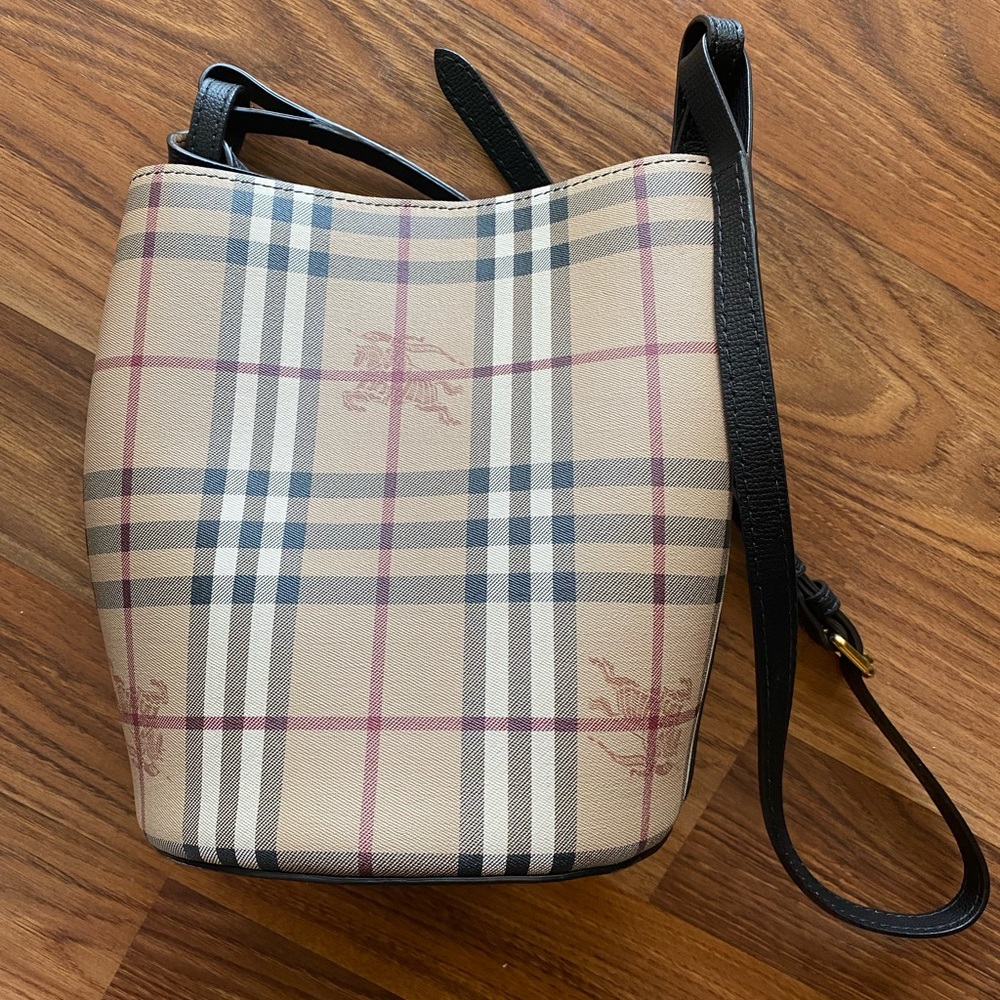 Leather and Haymarket check crossbody bucket bag in black.